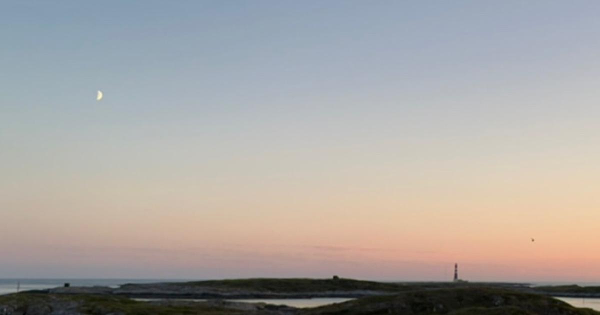Dusk landscape with lighthouse and moon